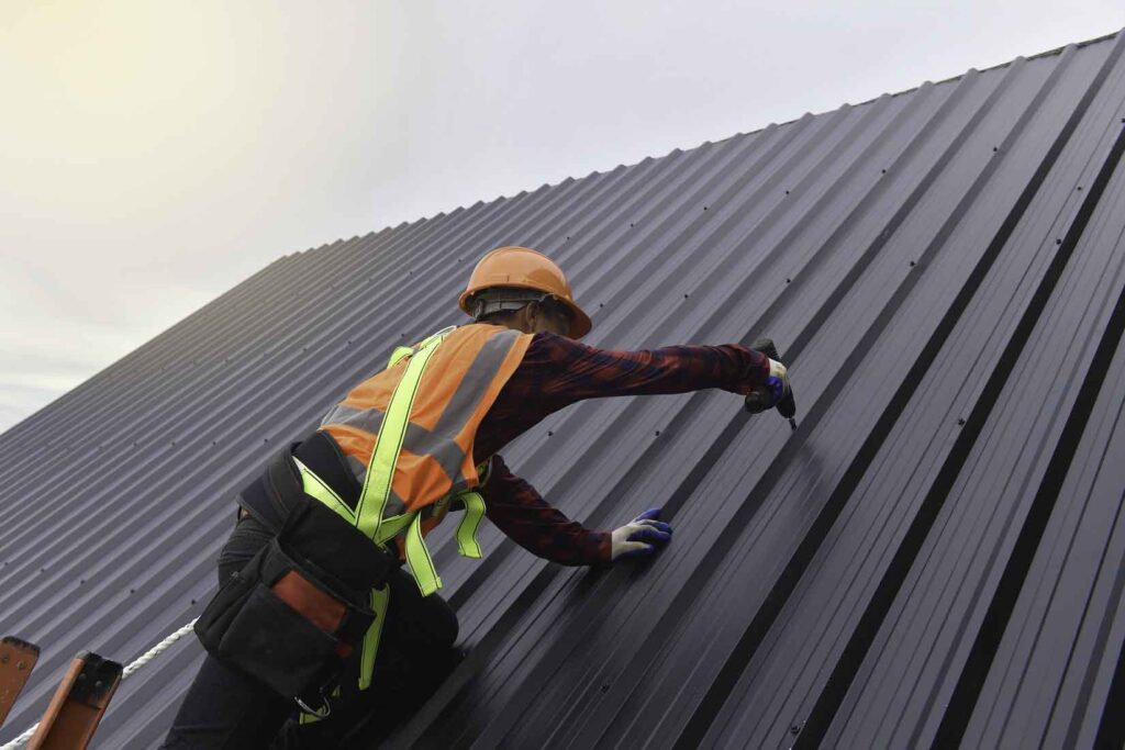 Modtek roofing Employee working on metal roof