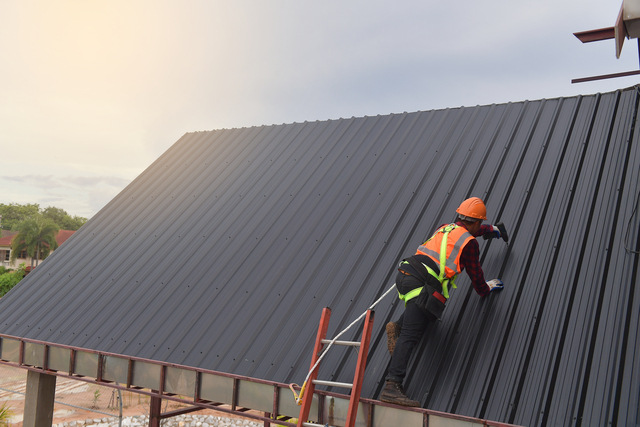 Roofers Port St Lucie working on a commercial metal roof